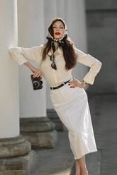 a lady wears a white denin skirt with a beige blouse